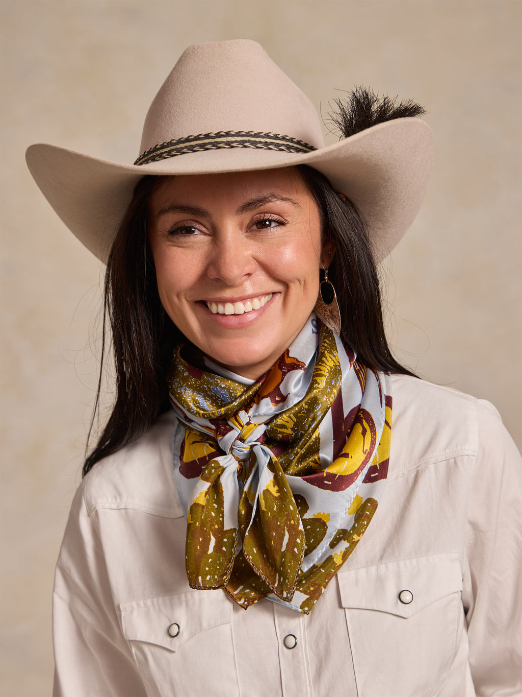 Wild rag scarf worn at neck, gold and brown Western animal map print.