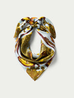Wild rag scarf folded triangle with tied knot, gold and orange animal print.