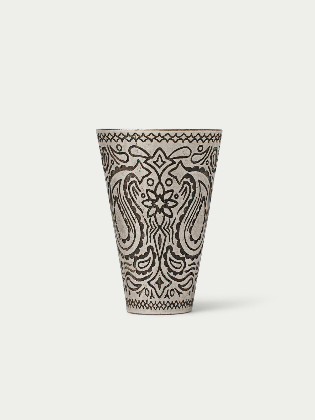 Paisley-patterned cone cup with black line art on a cream base, top rim visible