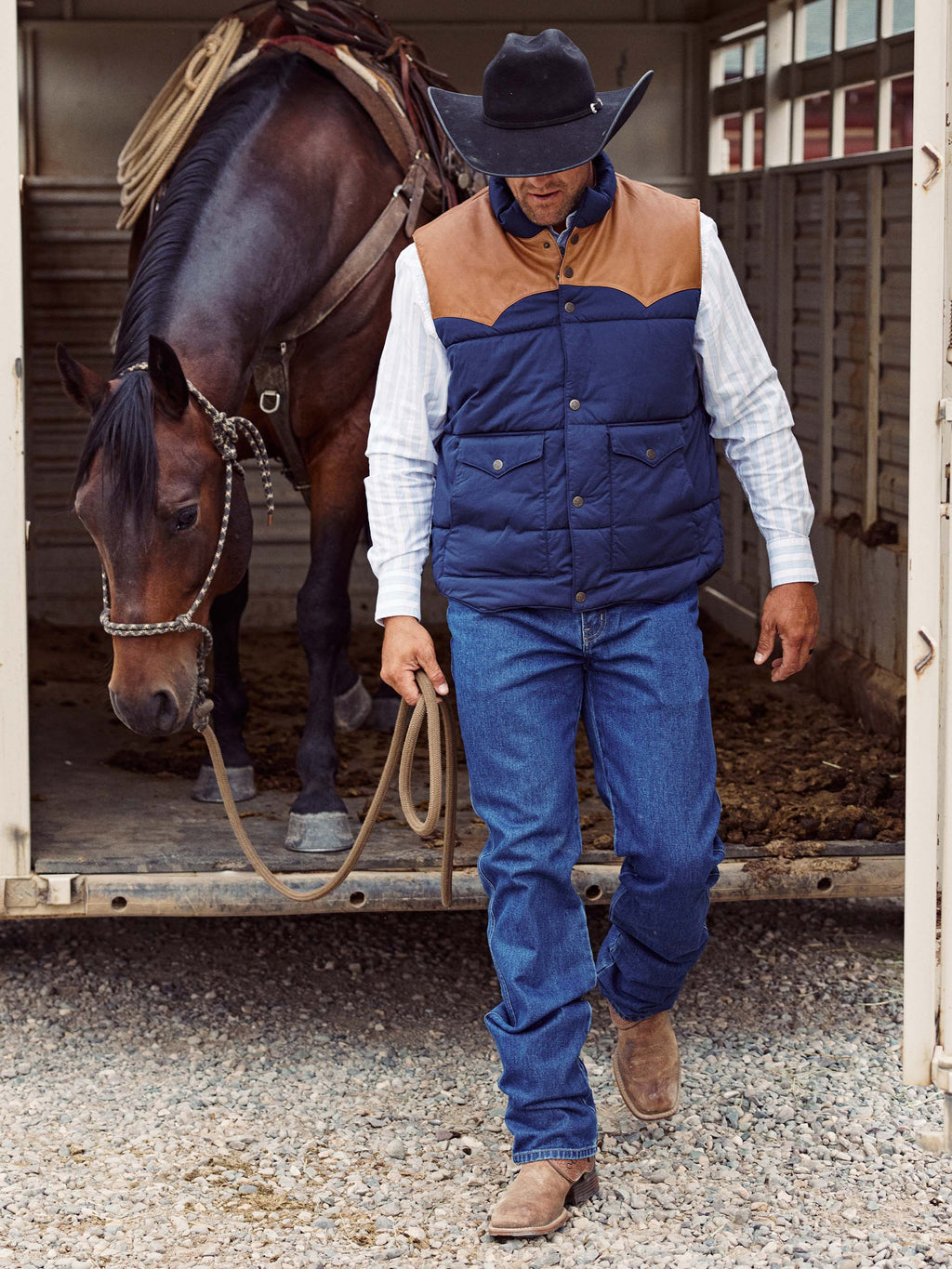 Blue denim overalls with chest pockets and buttoned bib, worn on model