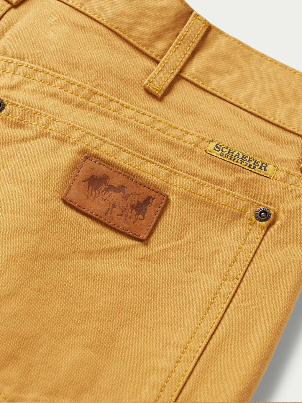 Suntan dungaree pants detail with leather brand patch and logo tab