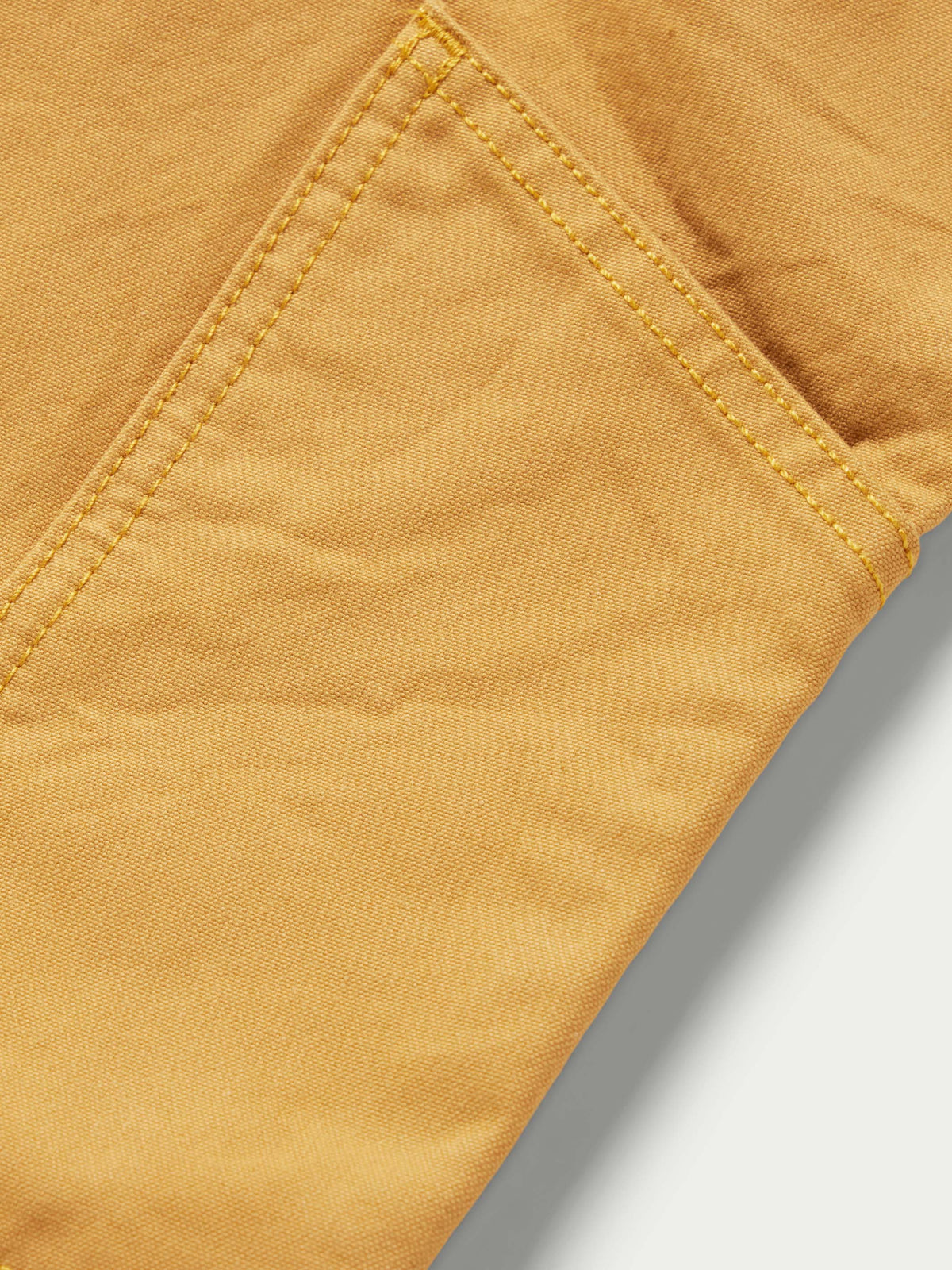 Suntan dungaree pants seam detail with reinforced topstitching