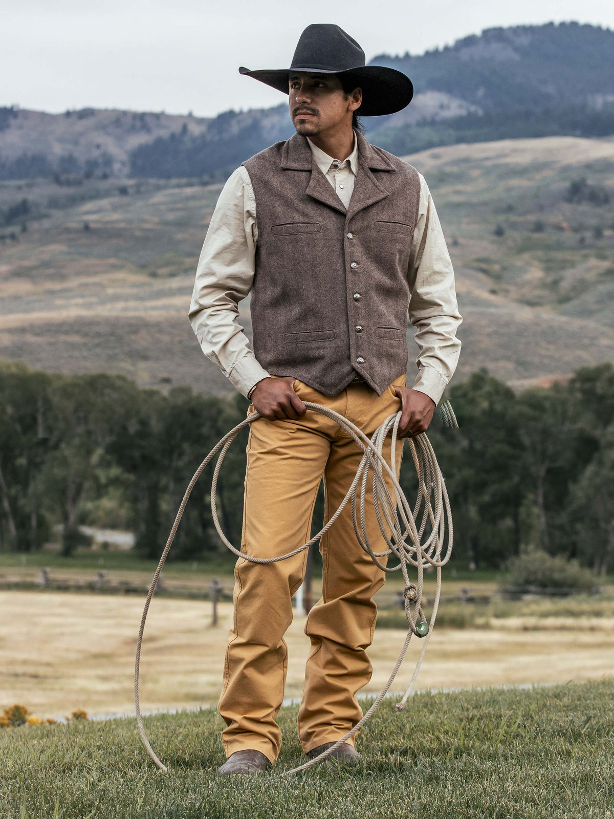 Tan dungaree pants with belt loops, front fly, and straight-leg fit
