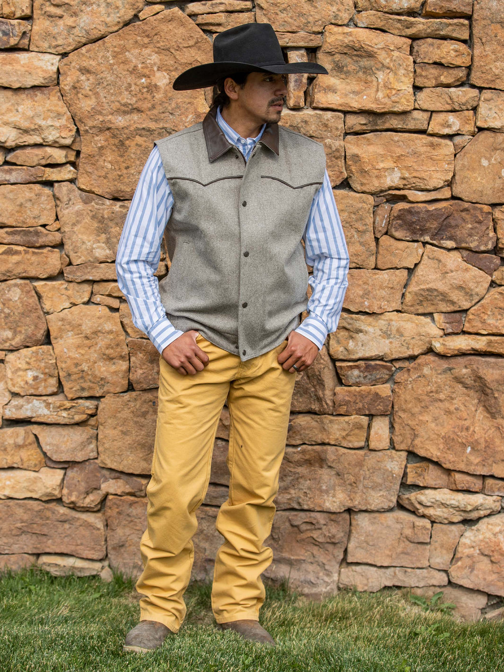 Tan dungaree pants with belt loops and front pockets standing outdoors