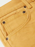Tan canvas dungaree pants waistband with metal snaps and belt loops