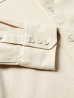 Natural denim snap shirt sleeve cuff detail with snap cuff and reinforced seam stitching