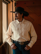 Natural denim snap shirt on model, front view with two chest pockets and snap front placket