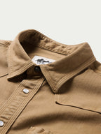 Tan snap-front western shirt collar with metal snap buttons