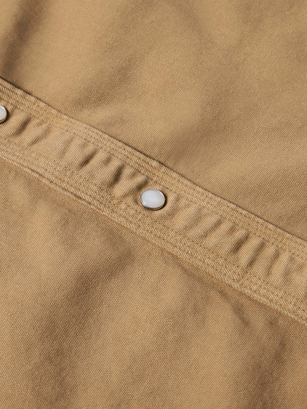 Tan shirt yoke with metal snap buttons