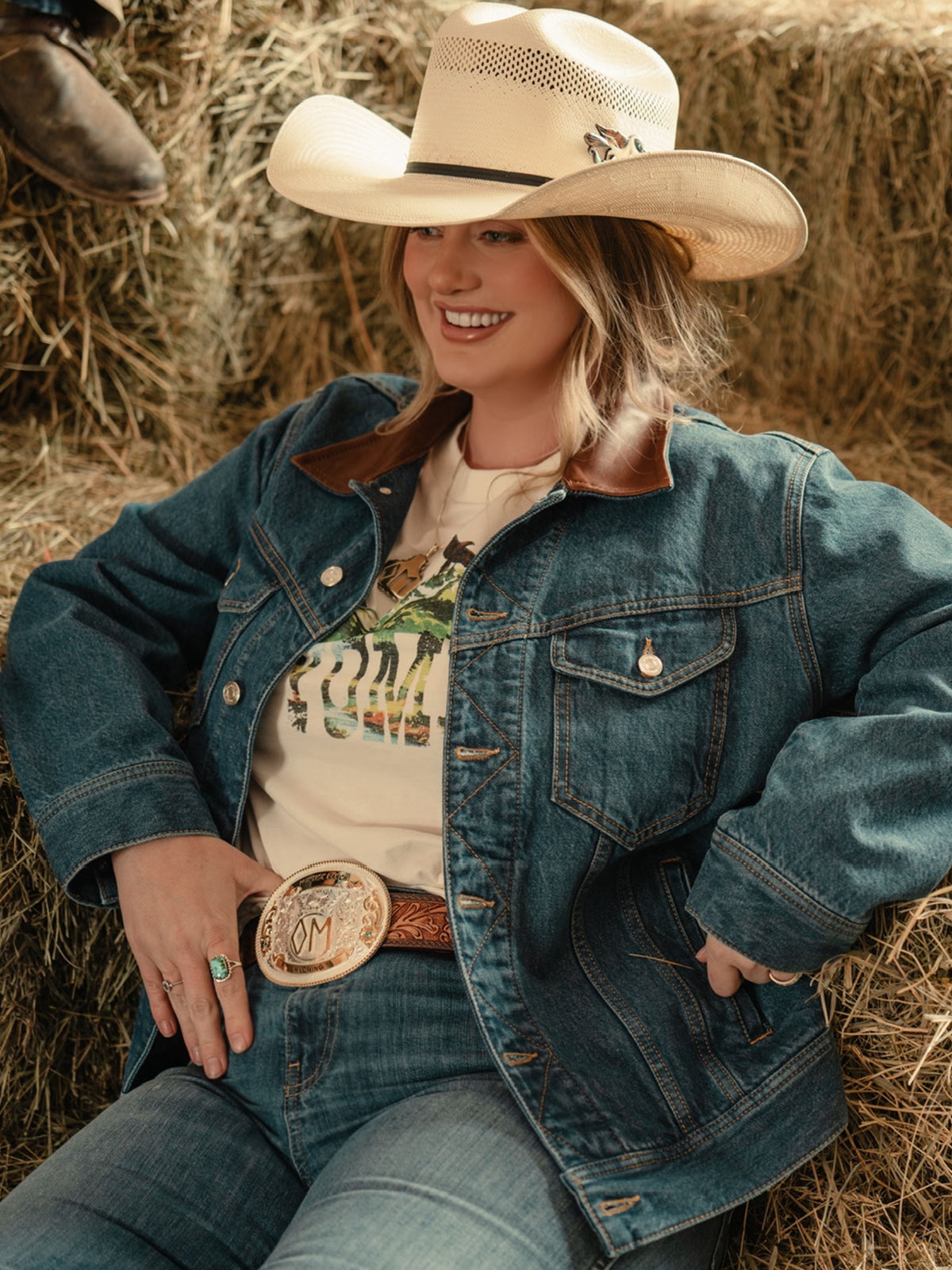 Bone tee with Wyoming graphic visible under denim jacket, crewneck short sleeves