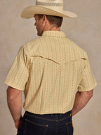 Short sleeve pearl snap western shirt, back view; light cream patterned with stitched yoke.