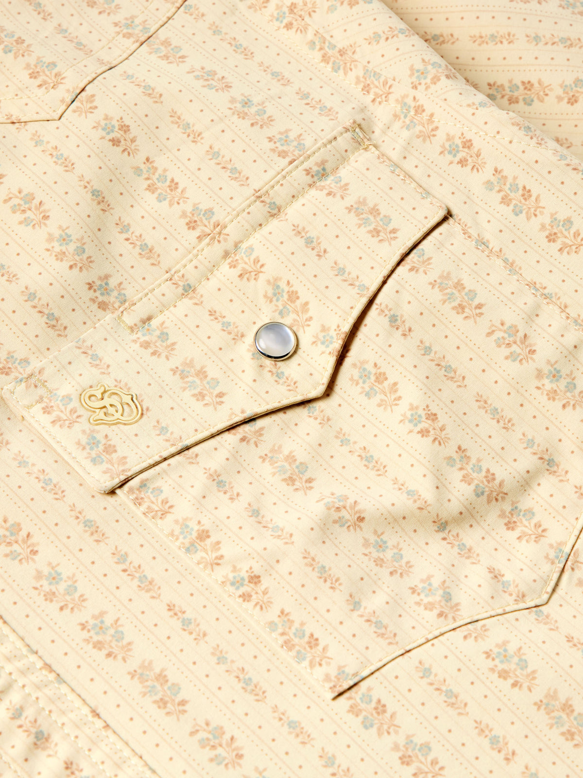 Detail of short sleeve pearl snap western shirt: metal snaps and decorative chest stitch.