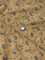 Short sleeve western shirt with pearl snap closure on patterned pocket placket.