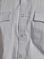 Light blue striped western snap-front shirt with chest pocket and metal snaps