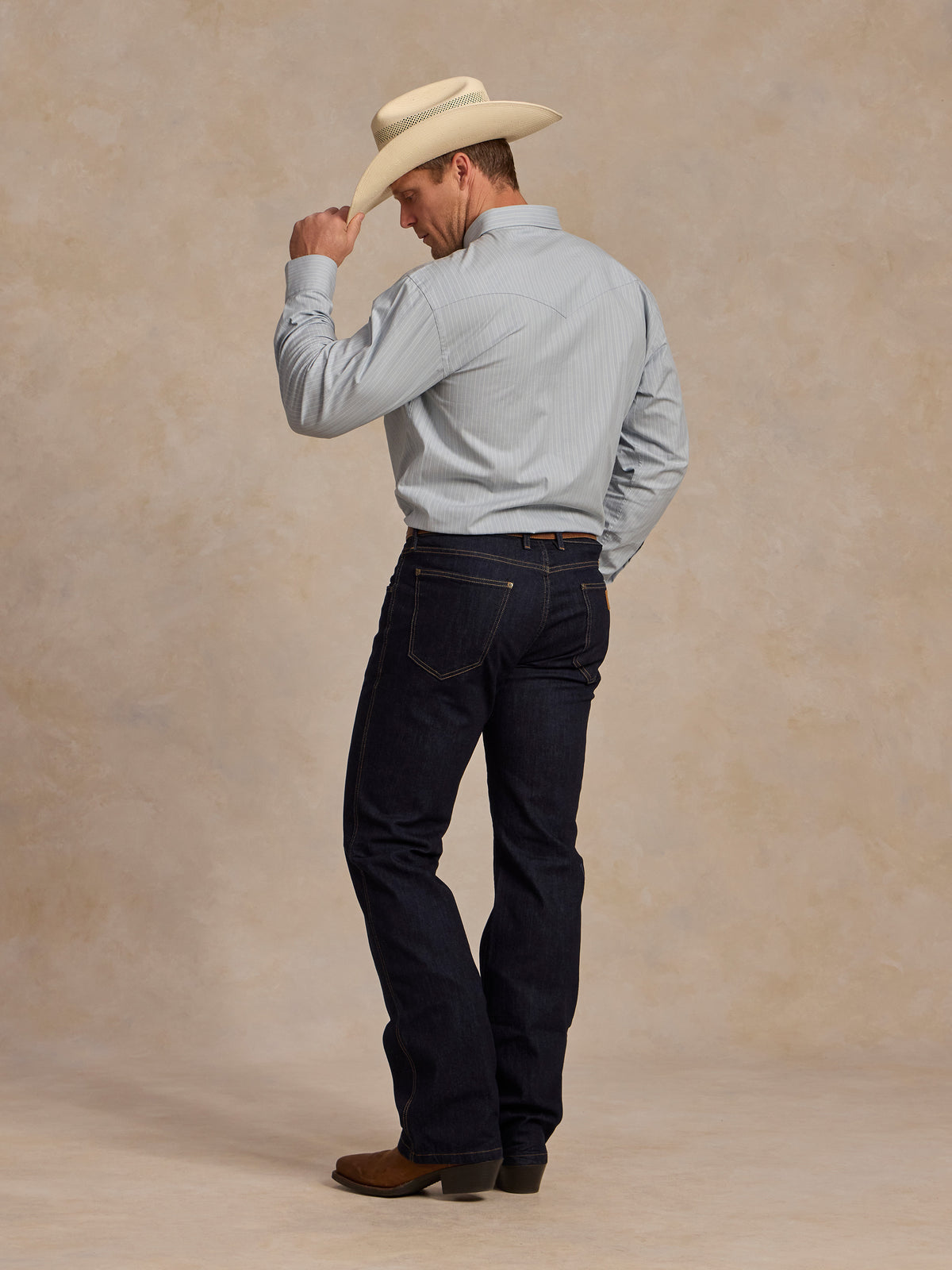 Light blue western button-down shirt worn with dark jeans, front view