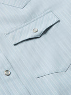 Light blue striped western shirt showing shoulder yoke and metal snap at placket