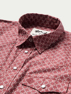 Cotton snap shirt collar and button placket in dark red with repeating geometric pattern.