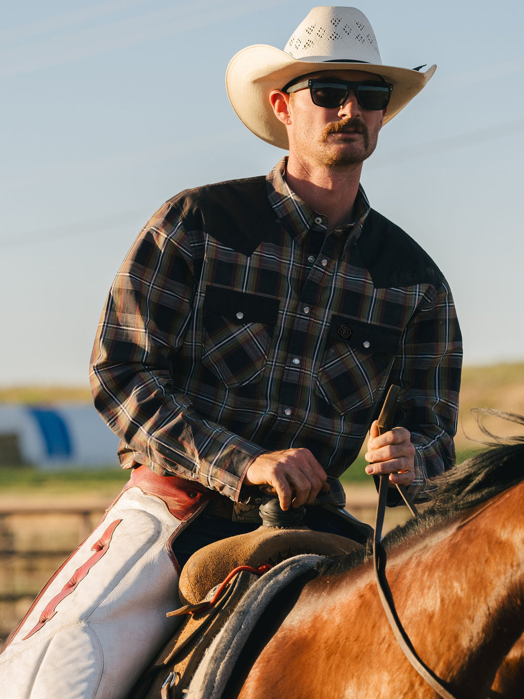Cotton snap shirt with dark plaid pattern, flap chest pockets, snap buttons