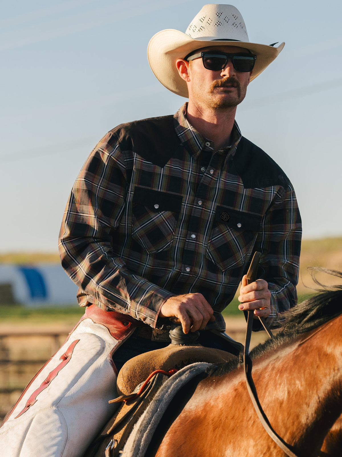 Cotton snap shirt with dark plaid pattern, flap chest pockets, snap buttons
