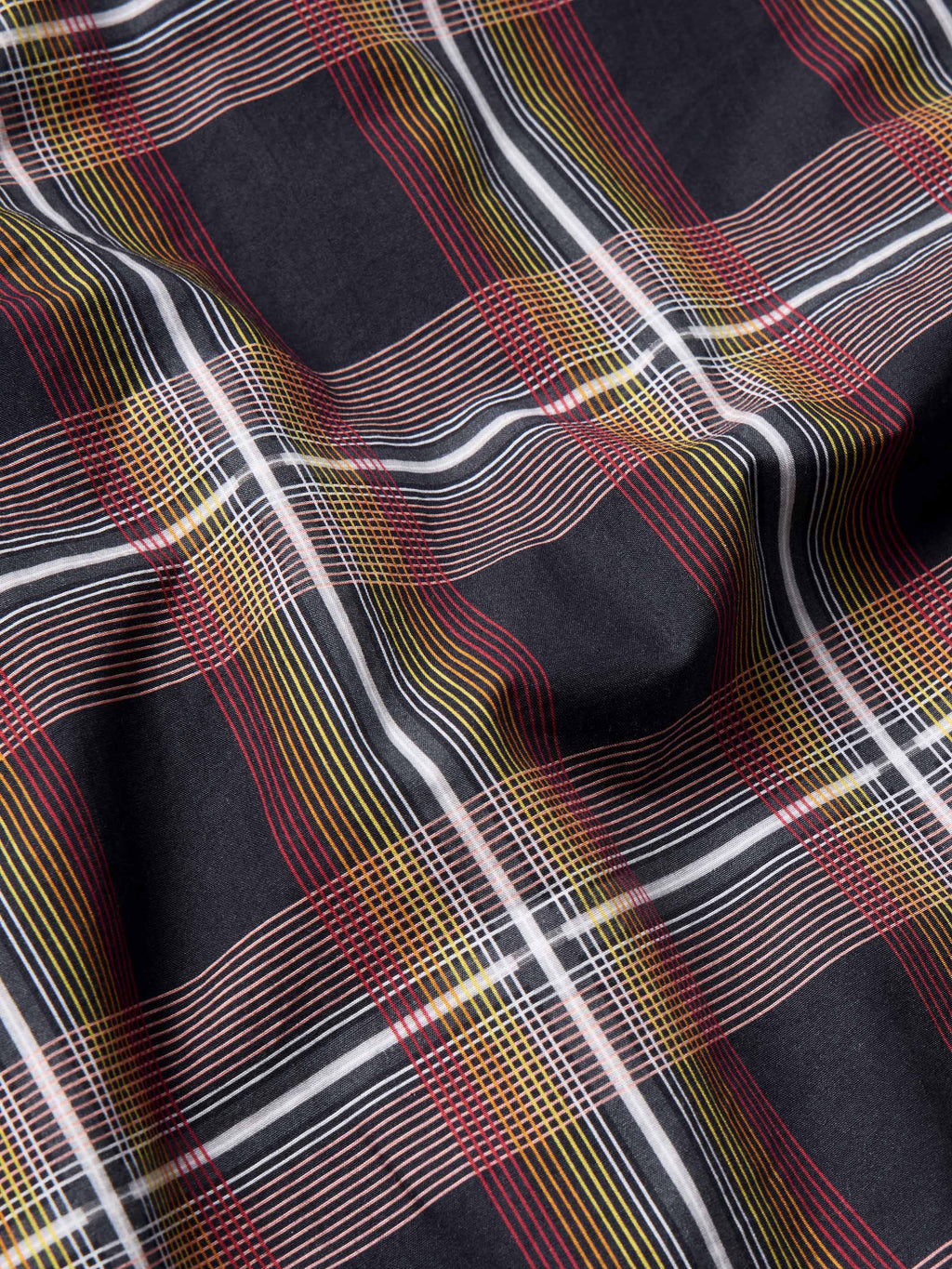 Cotton snap shirt fabric, dark plaid with red, yellow, white, and blue grid lines