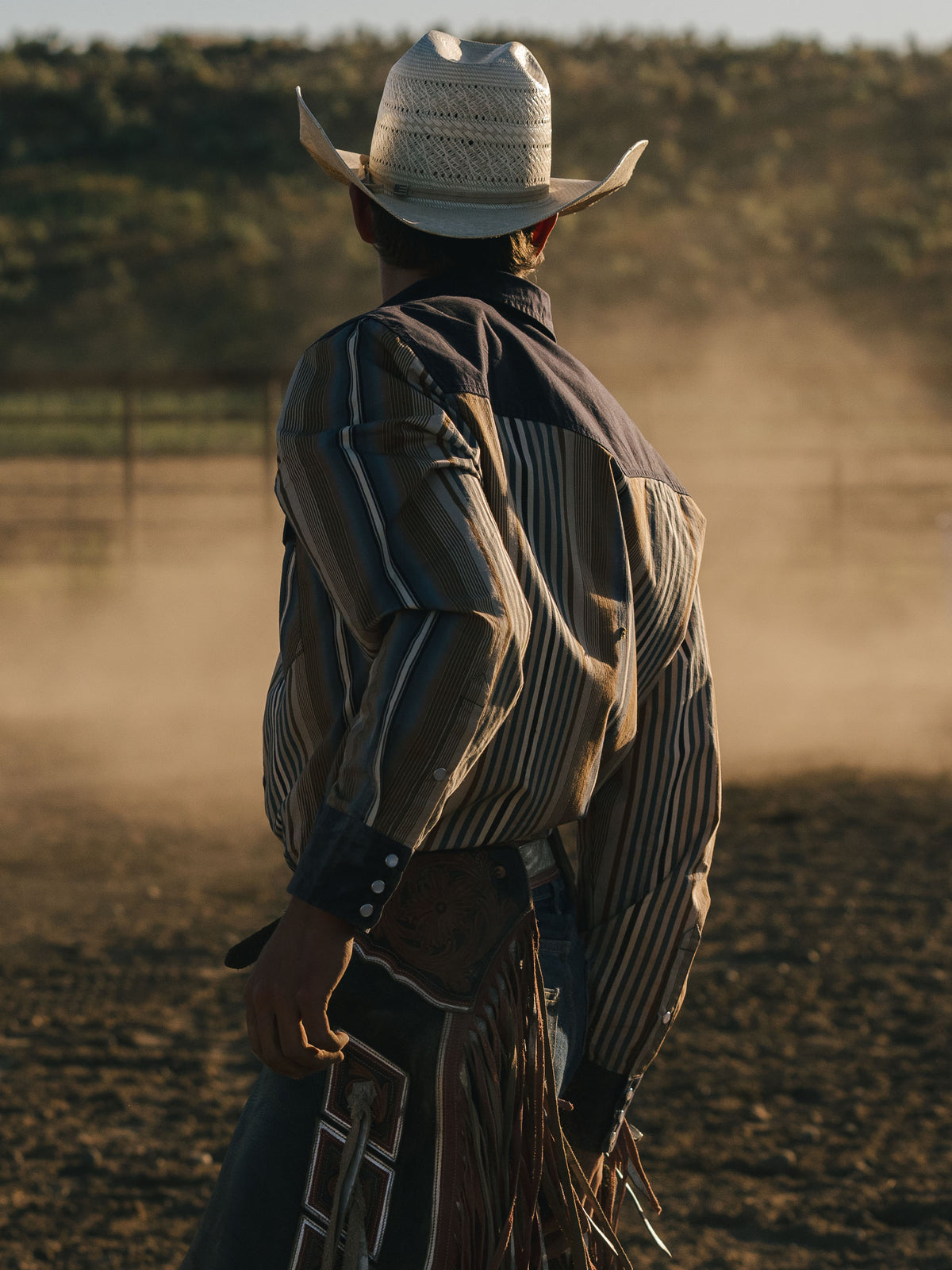 Cotton snap shirt worn by rider, blue and tan vertical stripes with navy accents