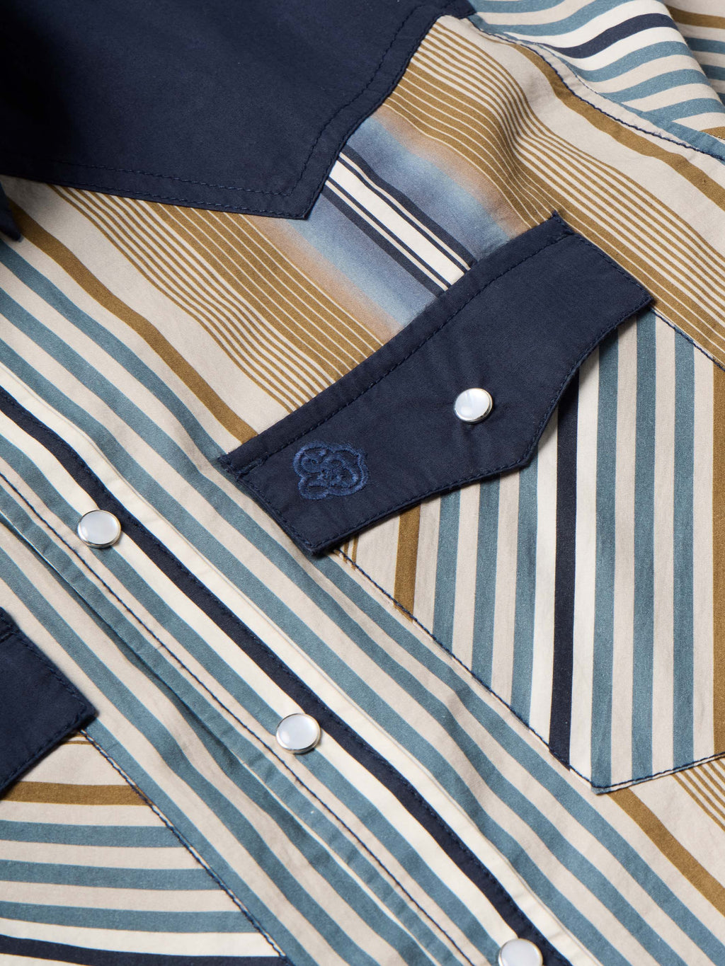 Cotton snap shirt shoulder and pocket detail, navy patch with snap closure on stripes