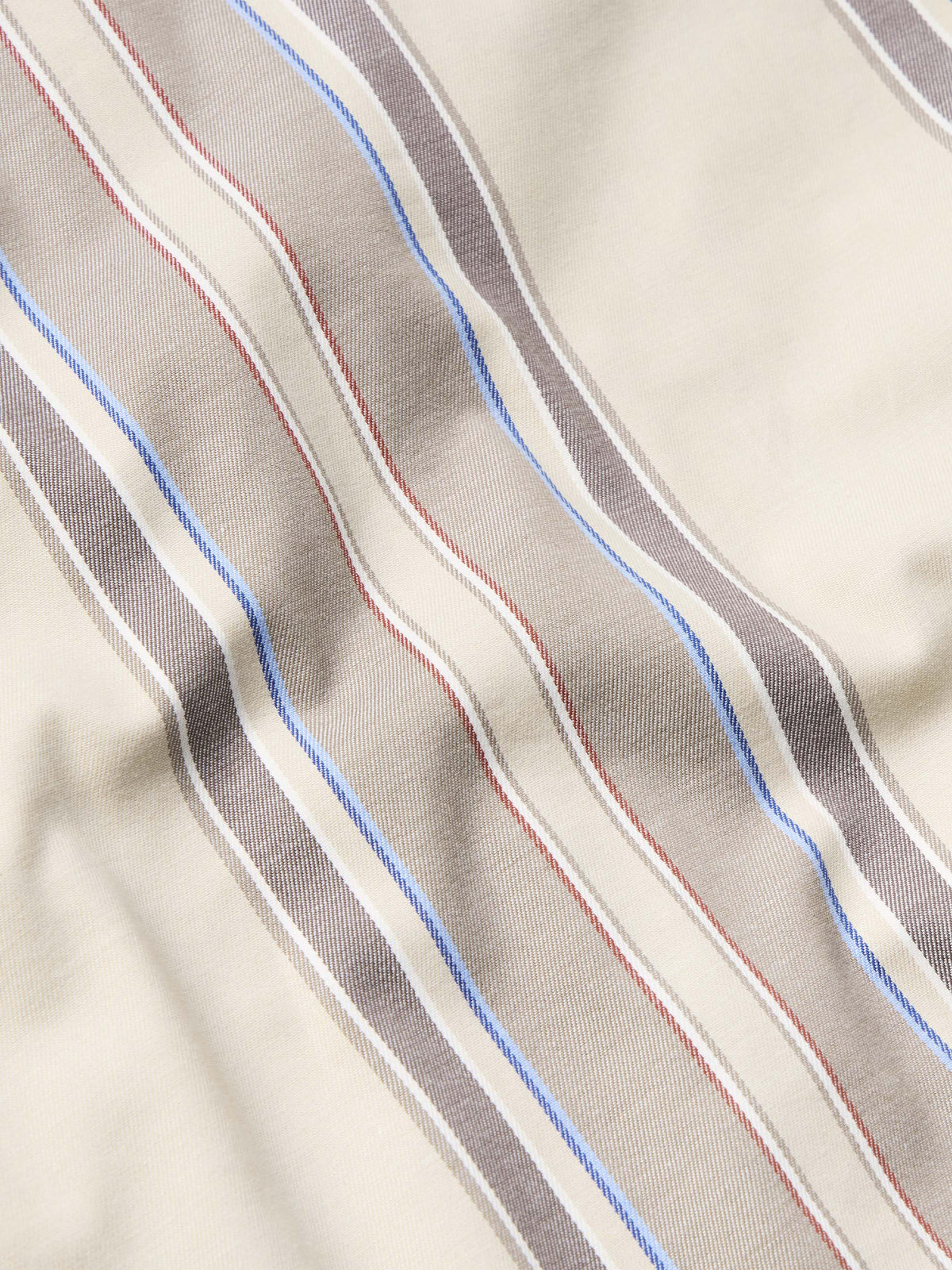 Tan western snap shirt fabric with blue, red, and gray vertical stripe pattern
