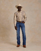 Western snap shirt in tan with blue and red stripes worn with jeans