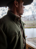 Olive wool overshirt with buttoned collar, worn in profile