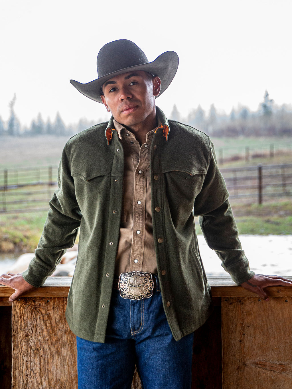 Olive wool overshirt worn by a cowboy hat model, buttoned front