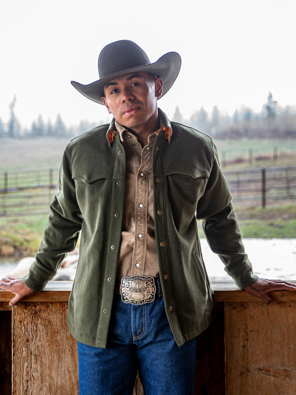 Olive wool overshirt worn by a cowboy hat model, buttoned front