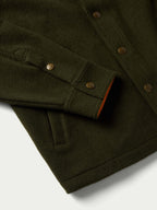 Olive wool overshirt with flap chest pocket, metal buttons, and orange trim