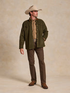 Olive wool overshirt with button front, flap chest pockets, and stand collar, model pose.