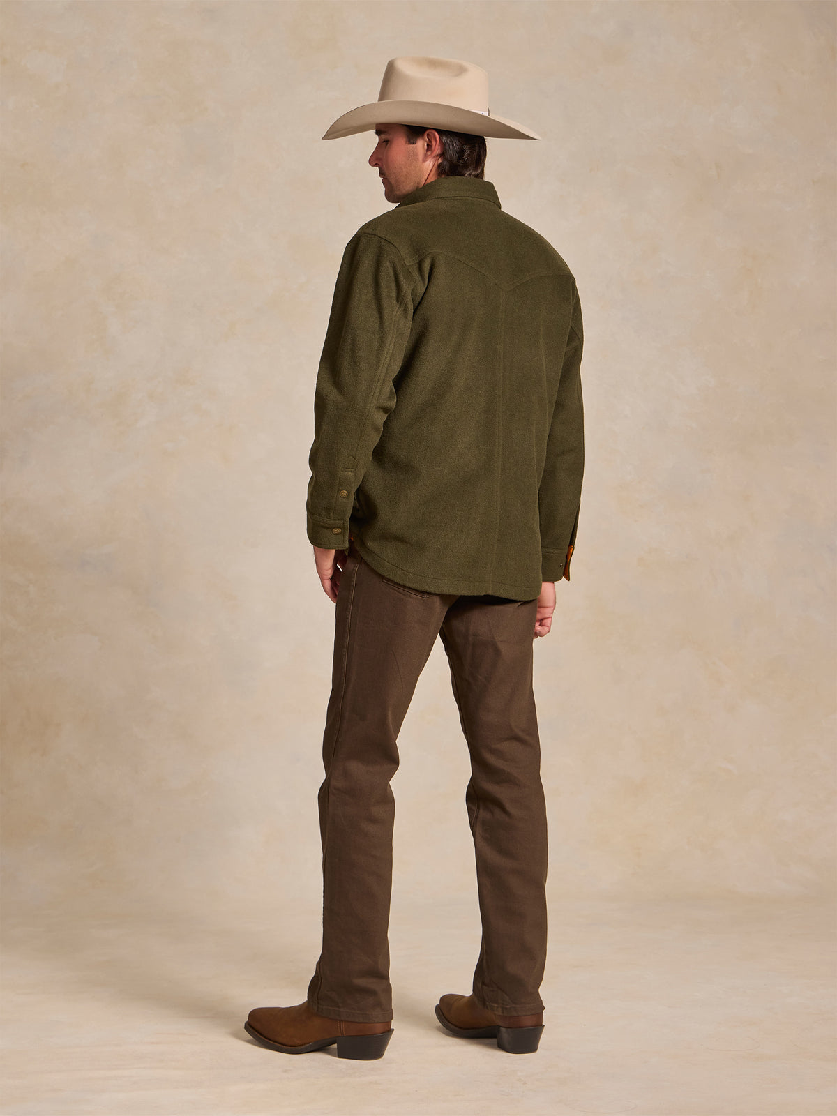 Olive wool overshirt viewed from the back, with long sleeves and buttoned hem.