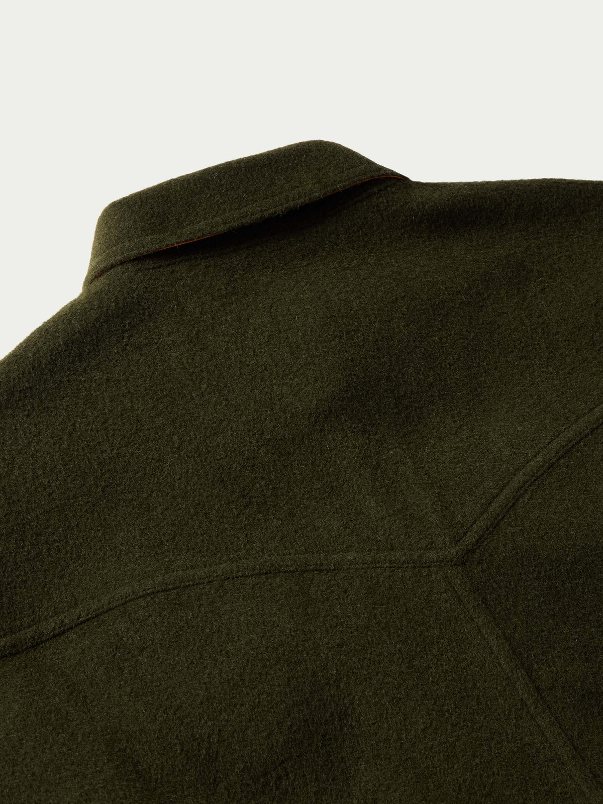 Olive wool overshirt close-up of shoulder seam and collar edge.