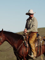 Sage western snap denim shirt worn by a cowboy, front view with snap placket
