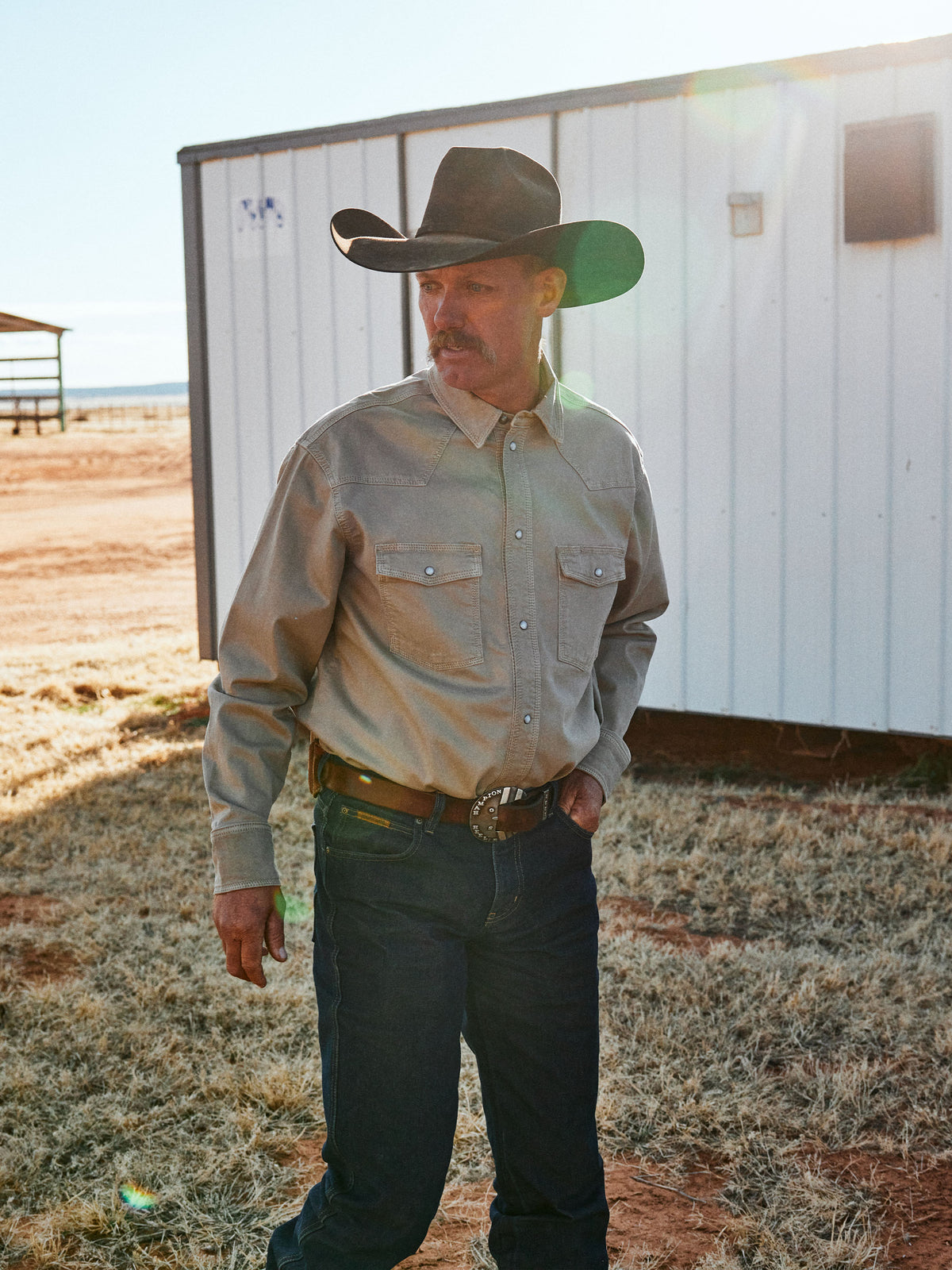 Sage western snap denim shirt worn by a man, showing chest pockets and cuffs