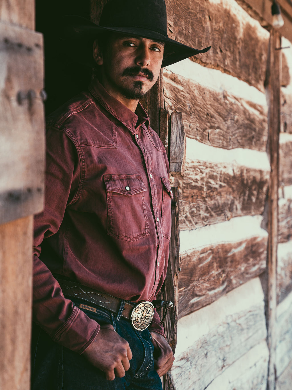 Rust Western denim snap shirt on model, front pockets and snap collar detail
