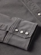 Men's western denim snap shirt sleeve cuff with two-snap button closure.