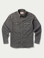 Men's western denim snap shirt front view with two chest flap pockets and snap buttons.