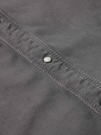 Men's western denim snap shirt neckline and button placket detail with snap hardware.
