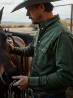 Dark olive western snap denim shirt on model, front side view with snap buttons