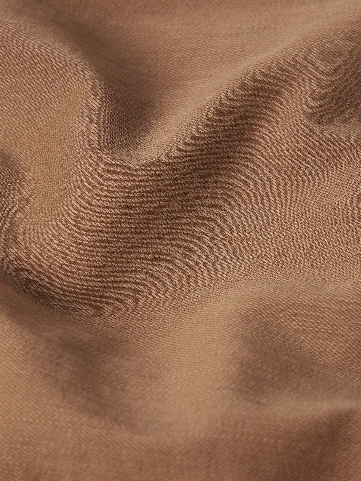 Khaki denim fabric close-up with fine woven texture