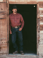 Rust Western denim snap shirt on model, long sleeves and snap front