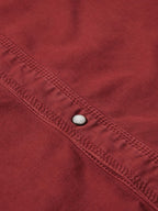 Rust Western denim shirt seam and snap-front placket detail