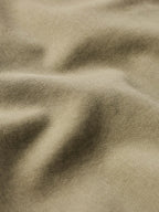 Sage denim fabric texture close-up with woven surface detail