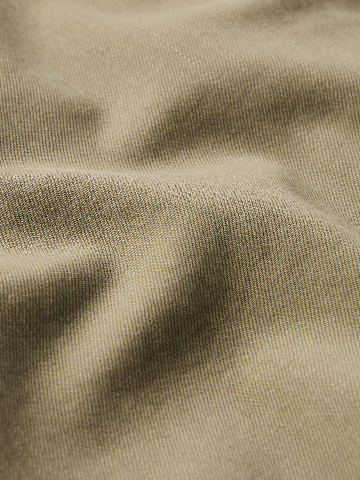 Sage denim fabric texture close-up with woven surface detail