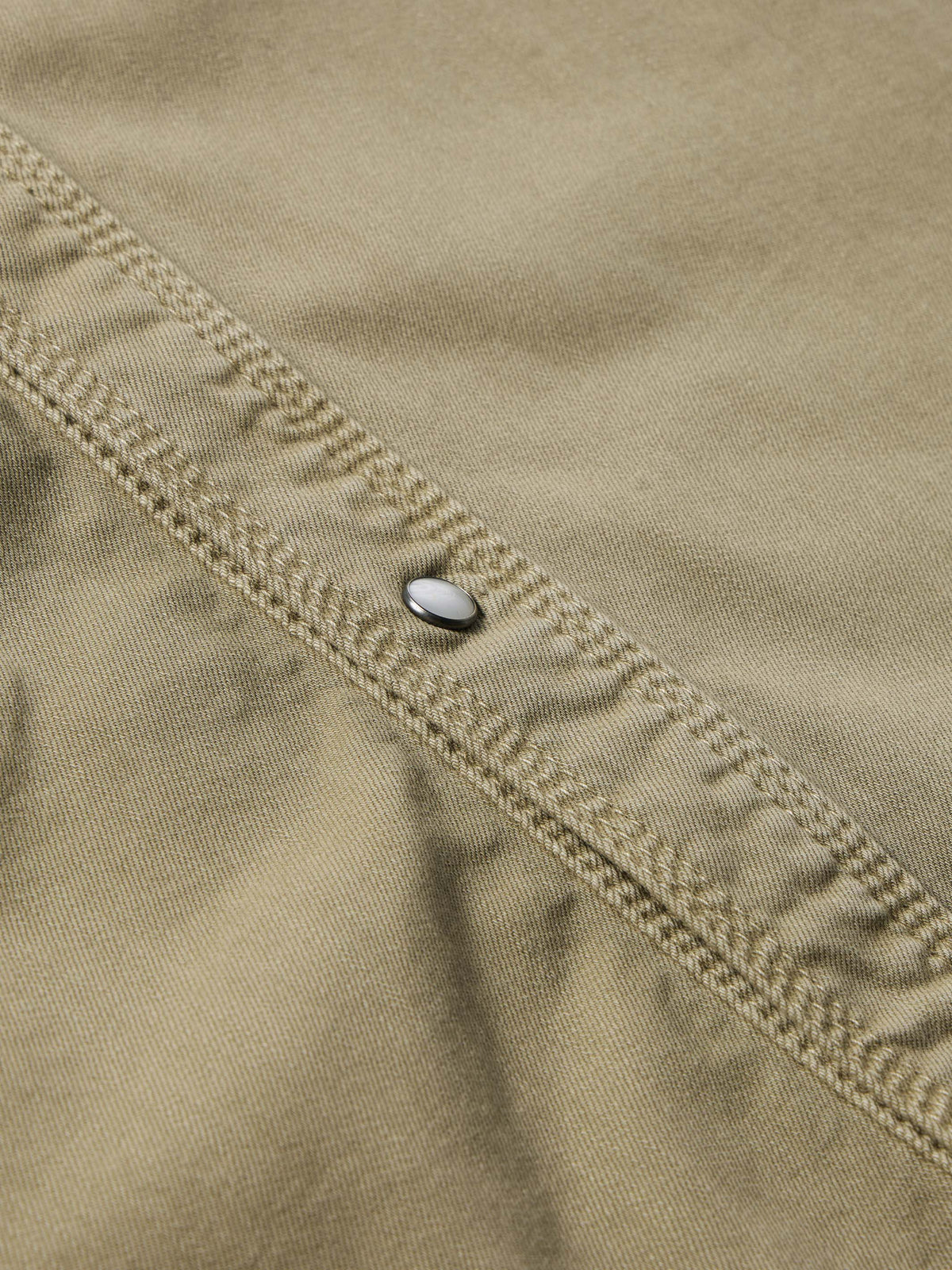 Sage western snap denim shirt placket close-up with topstitching