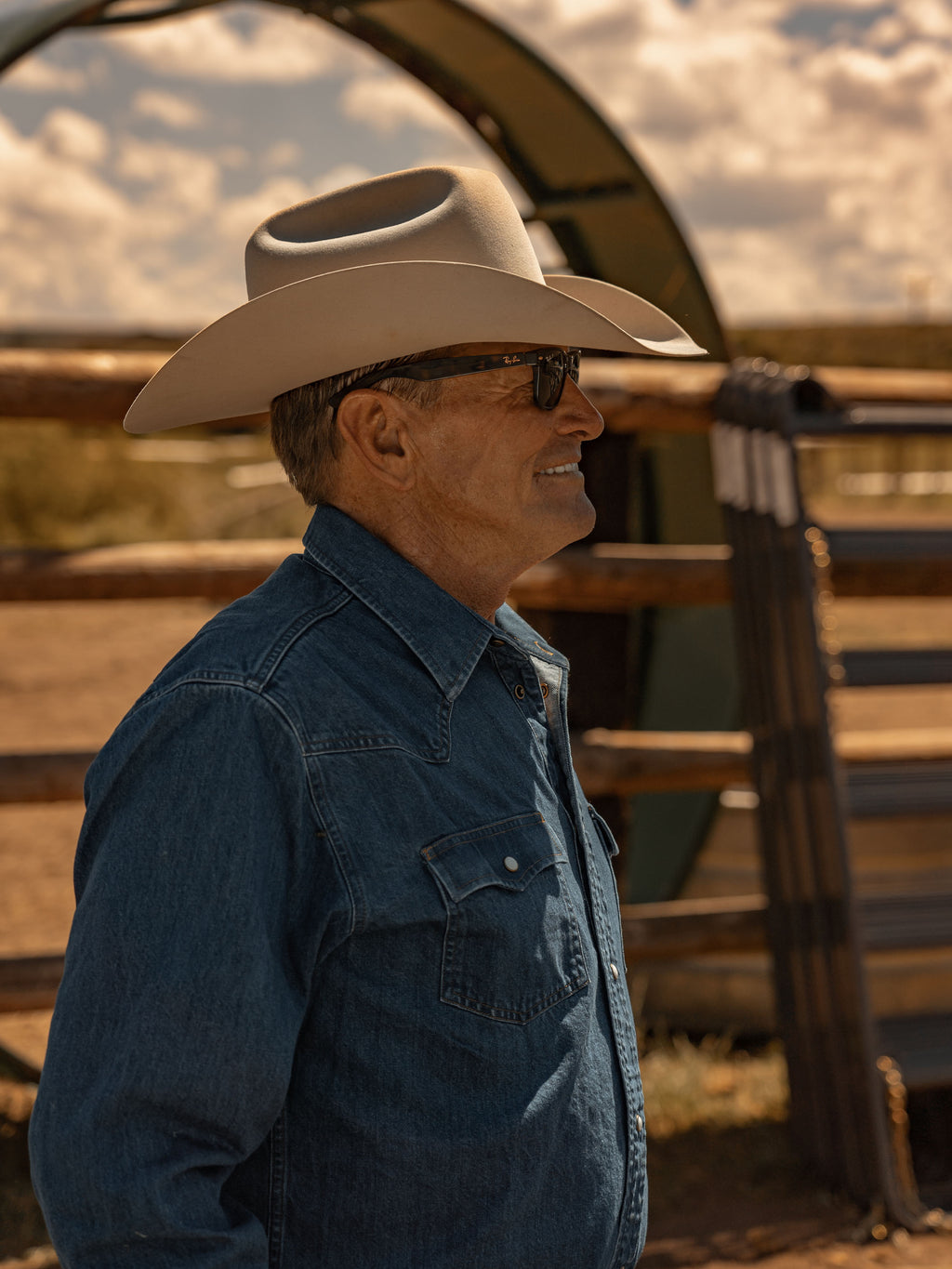 Dark indigo denim snap shirt worn by man with western hat, front view