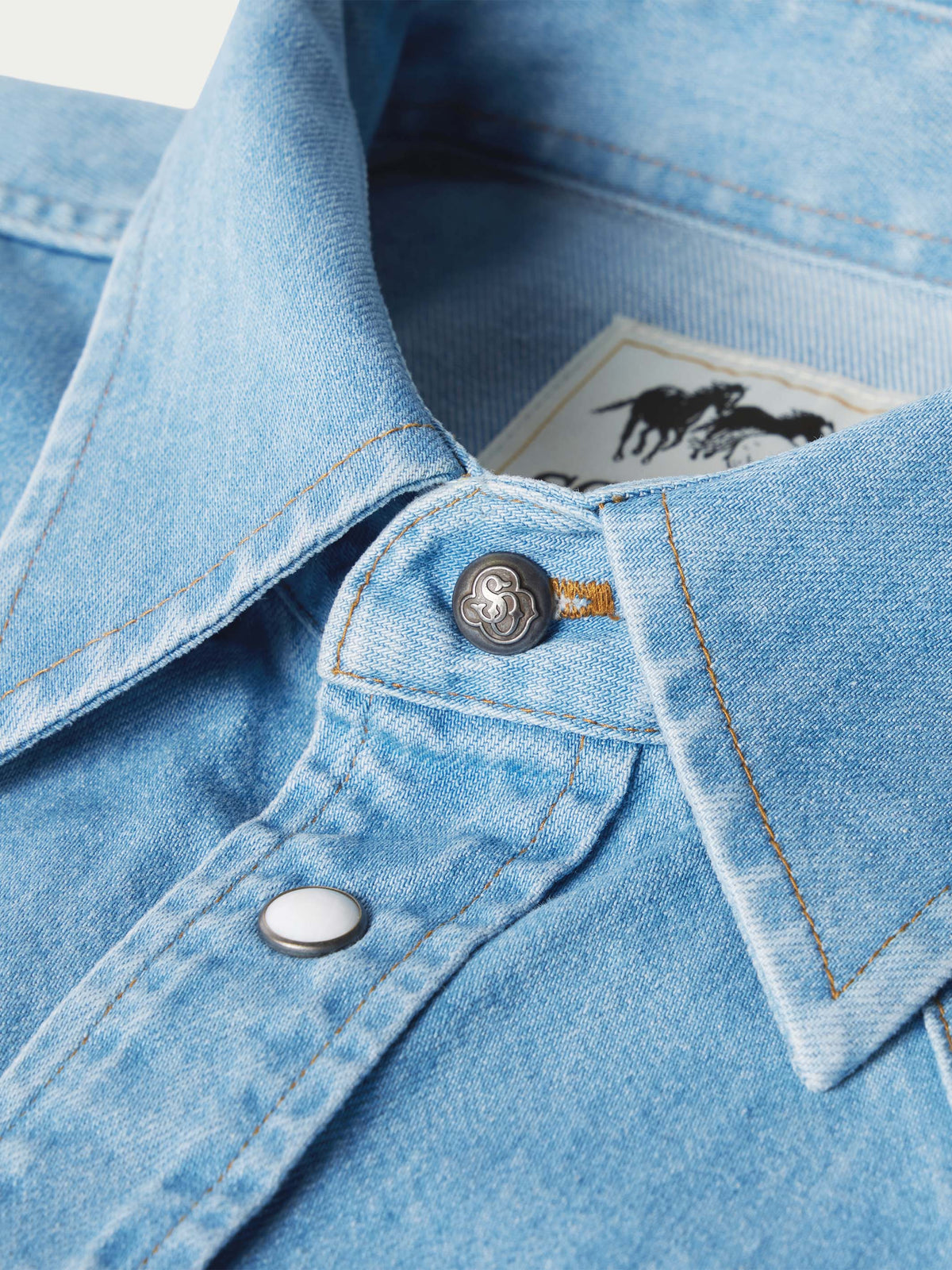 Light-wash denim snap shirt collar detail, snap placket and interior neck label